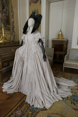 black headpiece and white ballgown on mannequin at the Louvre